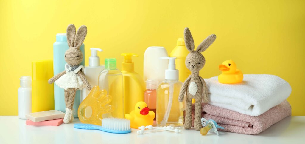 different-baby-hygiene-accessories-against-yellow-background-1-scaled