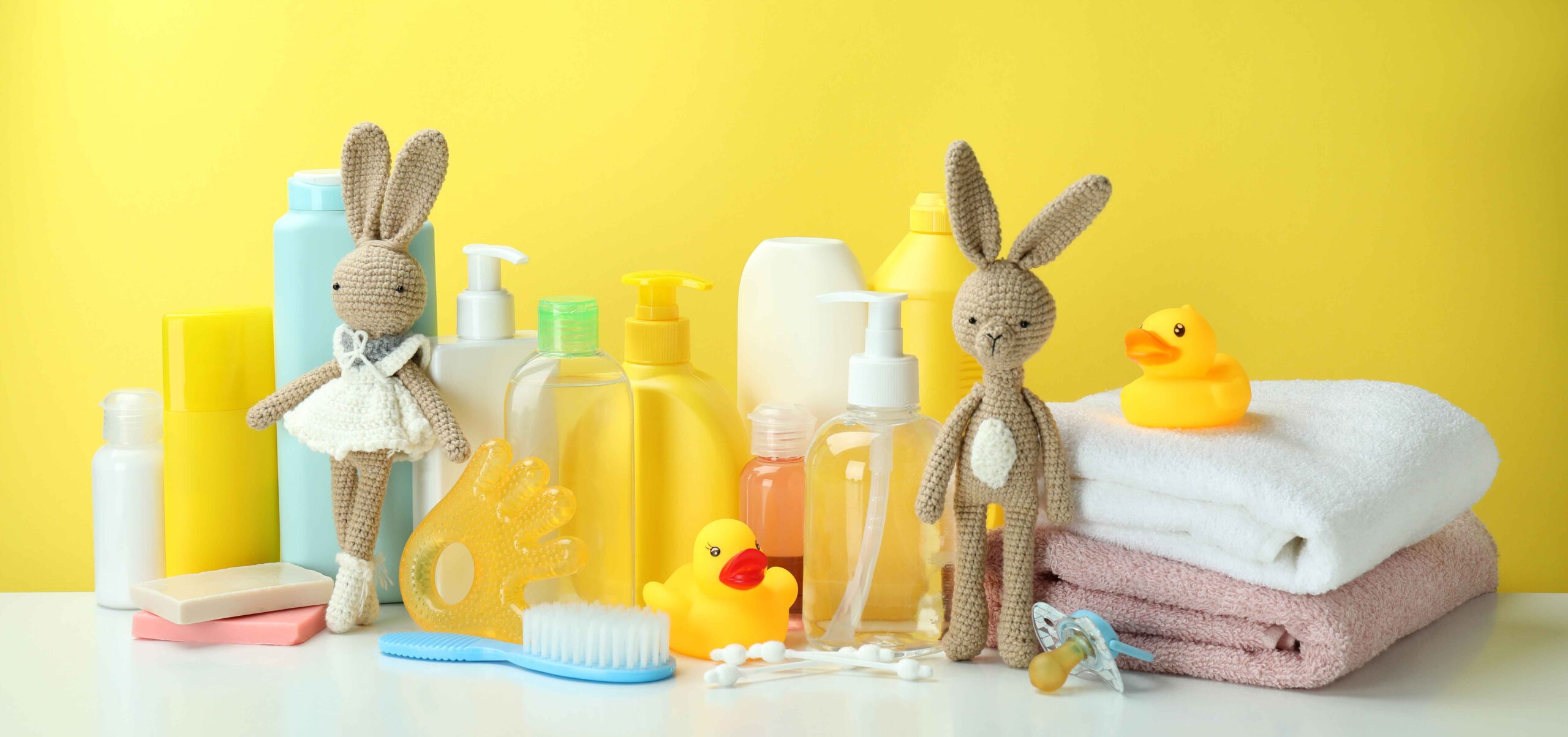 different-baby-hygiene-accessories-against-yellow-background-1-scaled